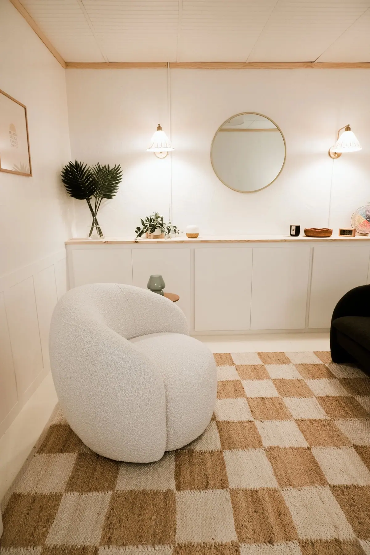 A soft armchair and neutral furnishings in the therapy office