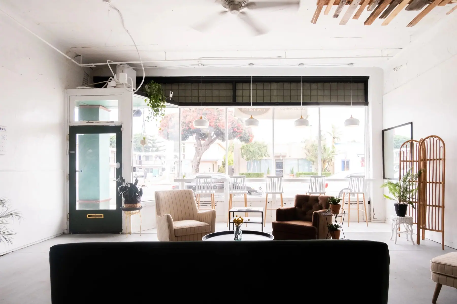 The bright front lounge and window counter at Coastal Coworking