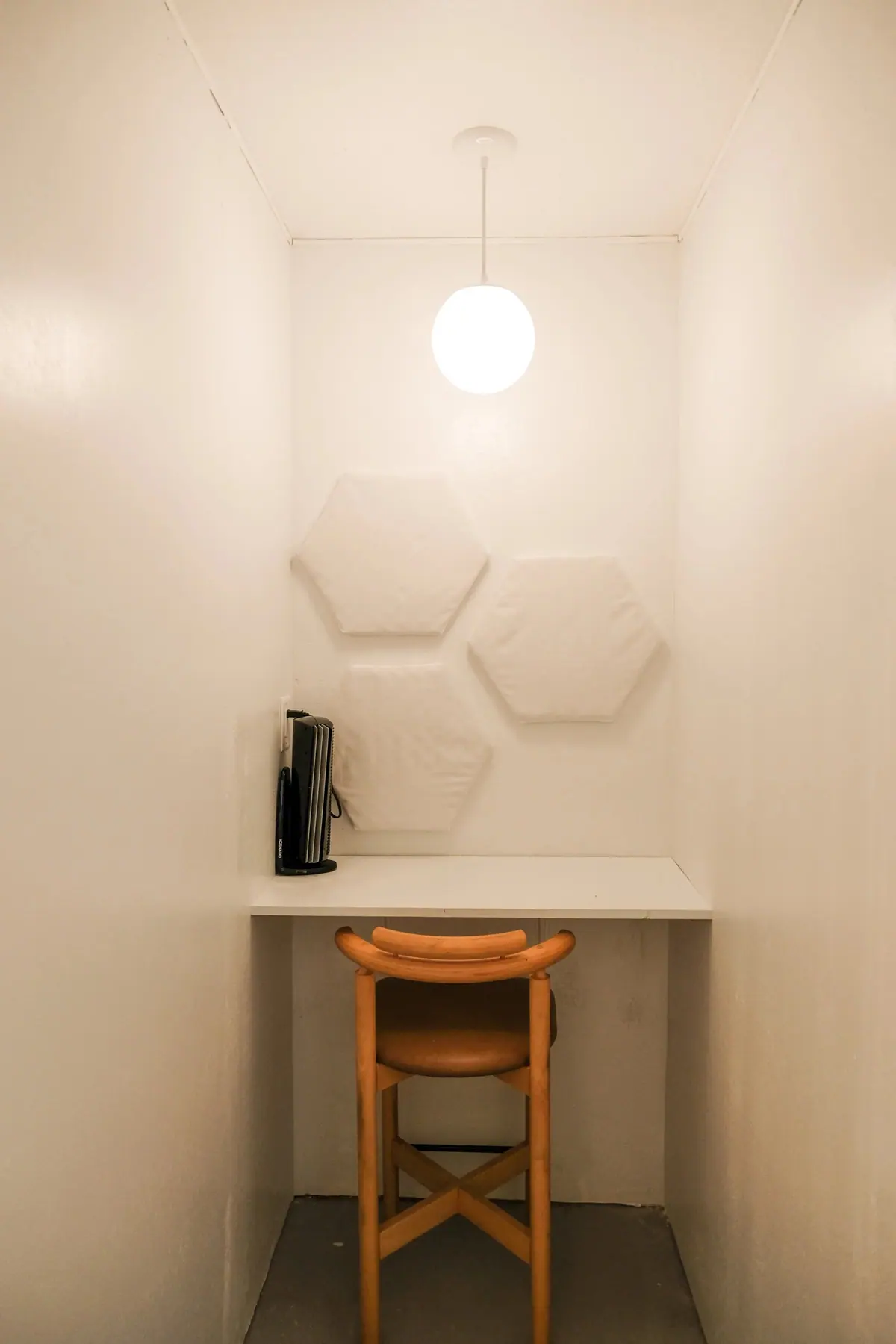 A private desk inside one of Coastal Coworking's phone booths